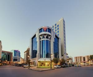 un grand bâtiment avec un drapeau américain dessus dans une ville dans l'établissement VERTA Al Olaya Hotel, à Riyad