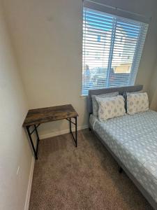 a bedroom with a bed and a table next to a window at Lovely Apartment in Austin shopping Dining in Cedar Park +14 photos