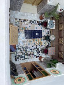 a bathroom with a tile fireplace in a room at Riad la Mentha in Fès