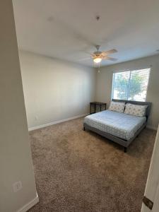 a bedroom with a bed and a ceiling fan at Lovely Apartment in Austin shopping Dining in Cedar Park