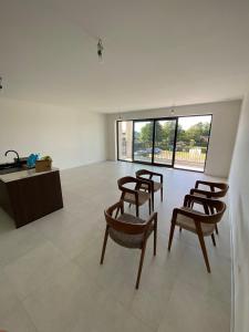 a room with chairs and a desk and windows at Luxury Apartment Antwerp Port Moerbeke 1 in Lokeren