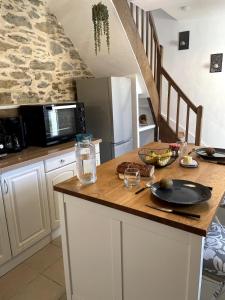 a kitchen with a wooden counter top with a refrigerator at Charming house with terrace in Laval