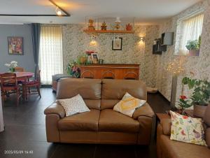 a living room with a couch and a table at La Grange de David gîte de standing 5 ch 5 sdb - Access-i in Hamoir +74 photos