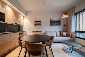 a kitchen and living room with a table and chairs at Levillas Levin Cranberry C24 in Levi +24 photos