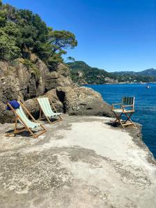 two chairs sitting on the shore of a body of water at Villa With Private Sea Access In Portofino in Portofino