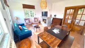 a living room with a table and a blue couch at Casa Naveira vistas mar en Foz in Foz