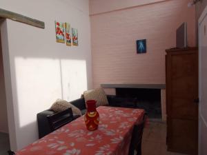 a dining room with a table with a red table cloth at Laura in Santa Rosa de Calamuchita