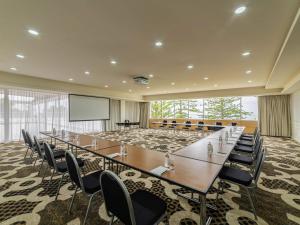 a large conference room with a long table and chairs at Novotel Wollongong Northbeach in Wollongong +112 photos