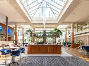 a lobby with a reception desk in a building at Novotel Wollongong Northbeach in Wollongong