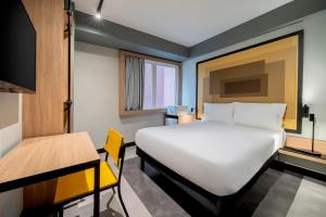 a room with a bed and a table and a desk at ibis Sao Paulo Paulista in Sao Paulo +41 photos