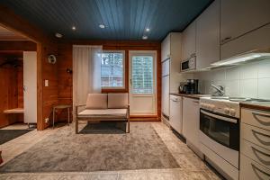 a kitchen with a table and a chair in it at Aurelfox Chalet A by Aavalevi in Levi