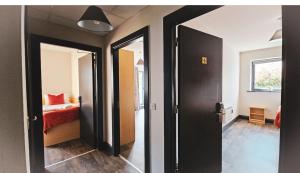 a room with a bedroom with a bed and a mirror at Clarion Village in Sligo