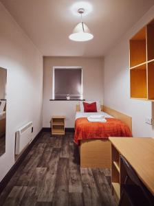 a small room with a bed and a window at Clarion Village in Sligo