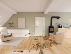 a living room with two chairs and a kitchen at Landschule Rhön in Poppenhausen