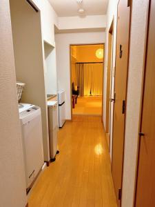 a hallway leading to a room with a kitchen and a hallway at Wa Shinsaka 902 7minute walk from Shinsakacho Station Maximum 4 people Separate bath and toilet Washing machine with dryer in Nagoya
