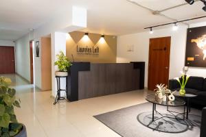 a lobby with a waiting area with a waiting room at Hotel Laureles Loft in Medellín