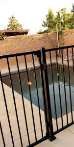 a fence with a body of water behind it at North Fontana pool house in Fontana