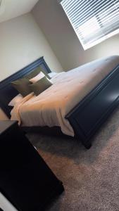 a large bed in a room with a window at North Fontana pool house in Fontana