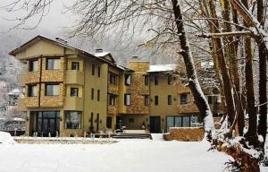 a large building with snow on the ground in front of it at Melies Boutique Hotel in Kato Loutraki