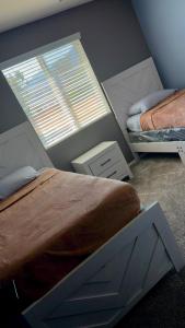 a bedroom with two beds and a window at North Fontana pool house in Fontana