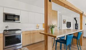 a kitchen with a wooden table and blue chairs at Private Aspen Haven Views in Woody Creek +15 photos