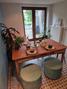 a wooden table and two stools with food on it at Chambre d'Amandine in Gerpinnes