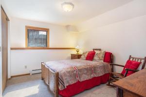 a bedroom with a bed and a table and a window at 714-A Meadow Court in Gypsum