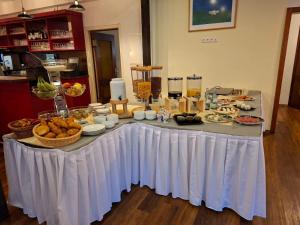 a table with a white table cloth with food on it at Hotel Sonne in Todtnau
