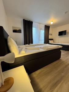 a hotel room with a large bed in a room at Orex Hotel in Waiblingen