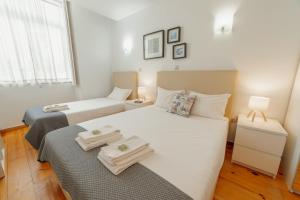 a bedroom with two beds with towels on them at Dear Porto By Hosty in Porto