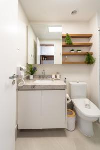 a bathroom with a sink and a toilet and a mirror at Edificio Le Petit - Próx Metrô Vila Mariana in Sao Paulo