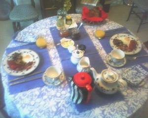 a table with plates of food and teapots at 80 Rushes Road, Petersfield GU32 3BP in Petersfield