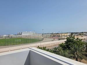 a view from the balcony of a building with a street at B21 Studio At Dar Al Hoboor دار الحبور in Seeb