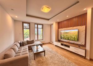 a living room with a couch and a large tv at Luxury apartment 304 - next to Sarajevo City Center in Sarajevo