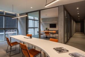 an office with a conference room with a table and chairs at On Domingos By Bstay in Sao Paulo