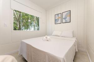 Postel nebo postele na pokoji v ubytování Vila UMI - Capão da Imbuia | Sustentabilidade e Conforto