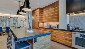 a kitchen with wooden cabinets and a blue counter top at Modern Alpine Escape Sophistication in Snowmass in Snowmass Village