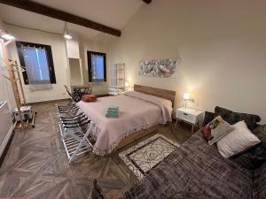 a bedroom with a bed and a living room at Il Correggiolo in Argenta