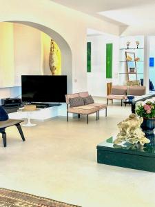 a living room with couches and a large screen tv at Villa With Private Sea Access In Portofino in Portofino