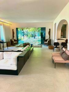 a large room with three beds and a living room at Villa With Private Sea Access In Portofino in Portofino