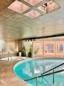a large swimming pool in a building with a ceiling at Howard Johnson Hotel Yerba Buena in Yerba Buena