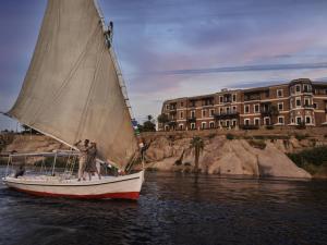 a man on a sail boat in the water at Sofitel Legend Old Cataract in Aswan