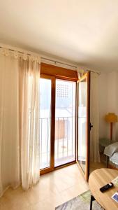 a living room with a sliding glass door with a window at Brisas de Guadalest in El Castell de Guadalest