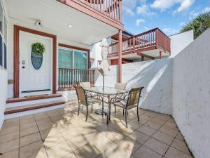 a patio with a table and chairs on a house at Driftwood Days Pet Friendly Beach Home in Myrtle Beach