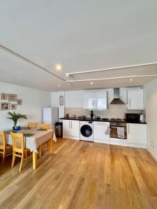 a kitchen and dining room with a table and chairs at Modern Apartment overlooking Andover High Street in Andover