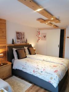 a bedroom with a large bed in a room at Au Coin Fleuri in Malmedy
