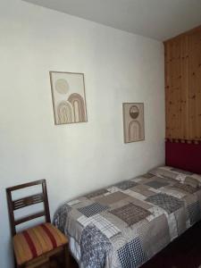 a bedroom with a bed and two pictures on the wall at Casa Rita in Bormio +24 photos