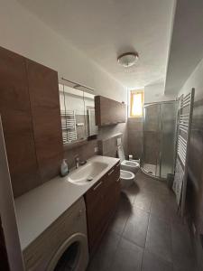 a bathroom with a sink and a toilet and a shower at Casa Rita in Bormio +24 photos