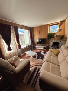 a living room with a couch and a fireplace at Casa Rita in Bormio
