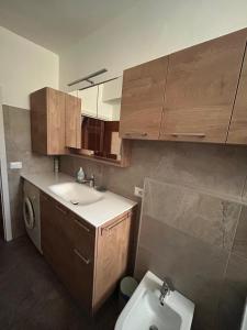 a small bathroom with a sink and a toilet at Casa Rita in Bormio